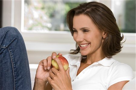 fruit conceptual - Smiling woman holding an apple Stock Photo - Rights-Managed, Code: 853-05523412