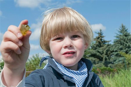 sustenence - Blond boy playing outside Stock Photo - Rights-Managed, Code: 853-05523490