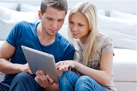 sitting room with people sitting - Young couple with ipad Stock Photo - Rights-Managed, Code: 853-05523623