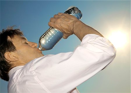 drinking water bottle - Man outdoors drinking from bottle of water Stock Photo - Rights-Managed, Code: 853-05840867