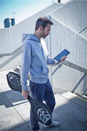 people ipad outdoors - Man with ipad and waveboard outdoors Stock Photo - Rights-Managed, Code: 853-06120409