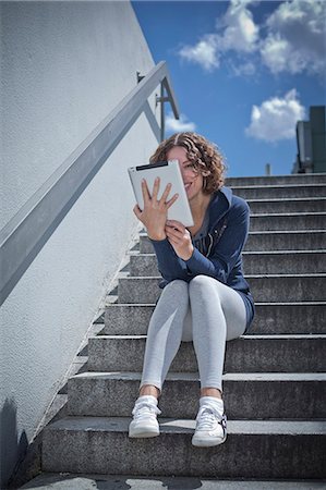 simsearch:853-06120359,k - Woman sitting with ipad on stairs Stock Photo - Rights-Managed, Code: 853-06120422