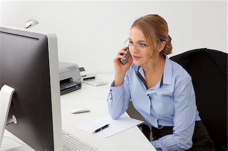 sit on top of desk - Young woman in office on the phone Stock Photo - Rights-Managed, Code: 853-06120586