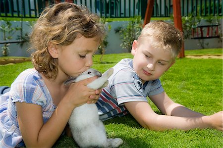 Boy and girl playing with a rabbit Stock Photo - Rights-Managed, Code: 853-06306021