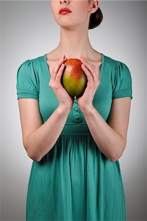 food dressings - Young woman holding a mango Stock Photo - Rights-Managed, Code: 853-06306059