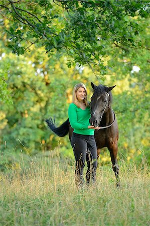 simsearch:853-07241791,k - Smiling teenage girl with horse on meadow Stock Photo - Rights-Managed, Code: 853-06306081