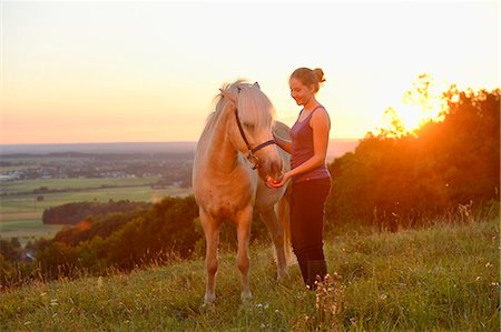 simsearch:853-06441961,k - Girl with horse on meadow at sunset Stock Photo - Rights-Managed, Code: 853-06306132