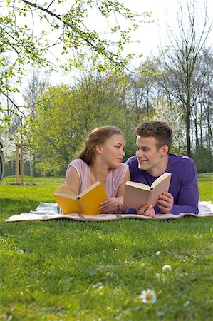 Young couple reading on a meadow Stock Photo - Rights-Managed, Code: 853-06441454