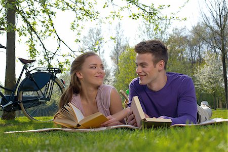 Young couple reading on a meadow Stock Photo - Rights-Managed, Code: 853-06441456
