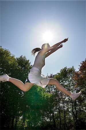 simsearch:853-06441524,k - Young woman jumping Stock Photo - Rights-Managed, Code: 853-06441493