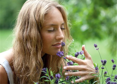 smelling hair - Young woman smelling at flowers Stock Photo - Rights-Managed, Code: 853-06441561