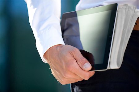 simsearch:853-03616802,k - Businessman carrying tablet PC and newspaper under his arm Stock Photo - Rights-Managed, Code: 853-06441617