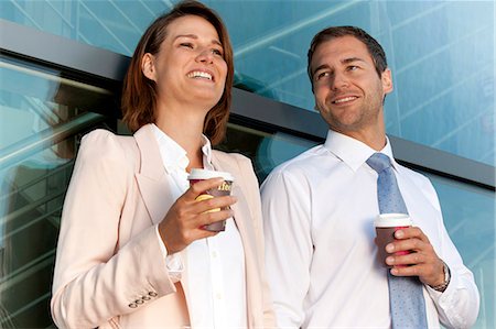 Businessman and businesswoman with coffee to go talking Stock Photo - Rights-Managed, Code: 853-06441655