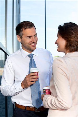 Businessman and businesswoman with coffee to go talking Stock Photo - Rights-Managed, Code: 853-06441664