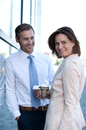 Businessman and businesswoman with coffee to go talking Stock Photo - Rights-Managed, Code: 853-06441668