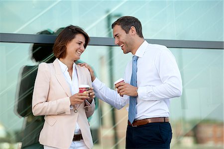 Businessman and businesswoman with coffee to go talking Stock Photo - Rights-Managed, Code: 853-06441677