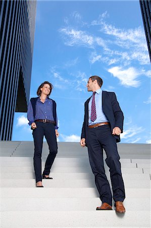 Businessman and businesswoman walking on stairs Stock Photo - Rights-Managed, Code: 853-06441701