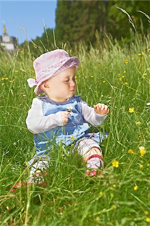 ranunculus sp - Female baby sitting in meadow with buttercups Stock Photo - Rights-Managed, Code: 853-06441920