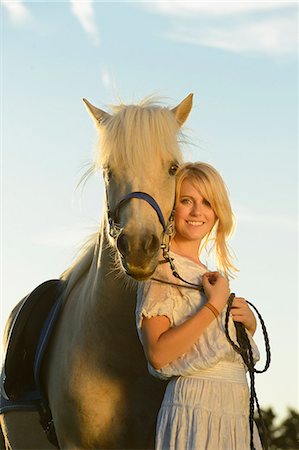 Smiling woman in white dress with horse Stock Photo - Rights-Managed, Code: 853-06442154