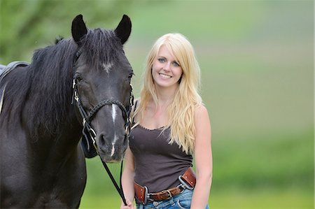 simsearch:853-07241791,k - Young woman standing beside a horse on a meadow, portrait Stock Photo - Rights-Managed, Code: 853-07148630