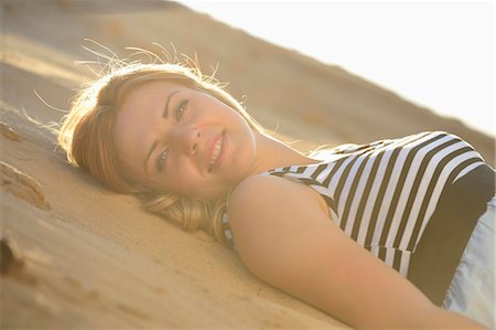 striped woman dress - Young woman wearing dress lying on beach Stock Photo - Rights-Managed, Code: 853-07148655