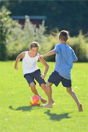 Two teenage boys playing football on a meadow, Upper Palatinate, Bavaria, Germany, Europe Photographie de stock - Rights-Managed, Code: 853-07241768