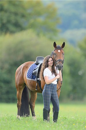 Teenage girl standing with a Mecklenburger horse on a paddock Stock Photo - Rights-Managed, Code: 853-07241783