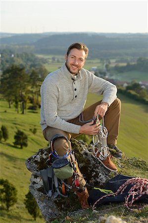 Man sitting on a rock with climbing equipment Stock Photo - Rights-Managed, Code: 853-07241897