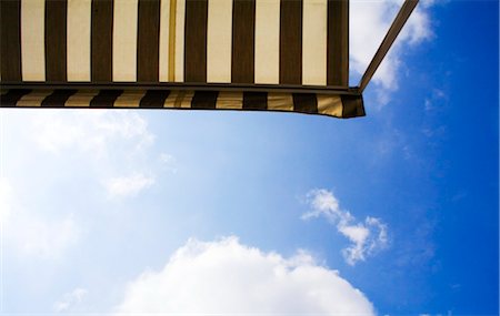 Marquee and cloudy sky, low angle view Stock Photo - Rights-Managed, Code: 853-02914100