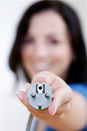 energy source - woman holding a plug, portrait Stock Photo - Rights-Managed, Code: 853-02914258