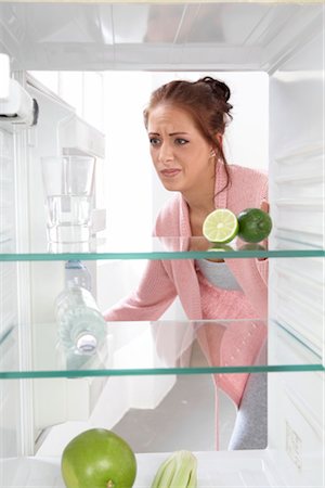 picture of a person deciding what to wear - woman looking into a cooler with some fruits Stock Photo - Rights-Managed, Code: 853-02914277