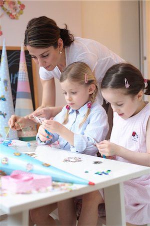 friends women indoors happy middle aged - Two girls doing crafts with mother Stock Photo - Rights-Managed, Code: 853-02914361