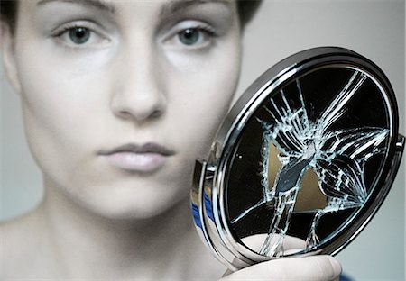 woman looking into a broken mirror, portrait Stock Photo - Rights-Managed, Code: 853-02913544