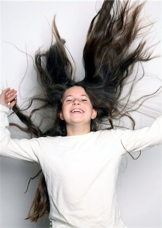 preteen girl hair - Laughing girl with long dark hair Stock Photo - Rights-Managed, Code: 853-02913636