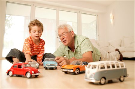 Grandfather and grandson playing with cars Stock Photo - Rights-Managed, Code: 853-02913659