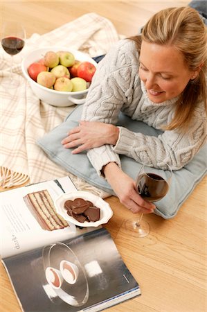 Woman with wine glass lying on floor Stock Photo - Rights-Managed, Code: 853-02913685