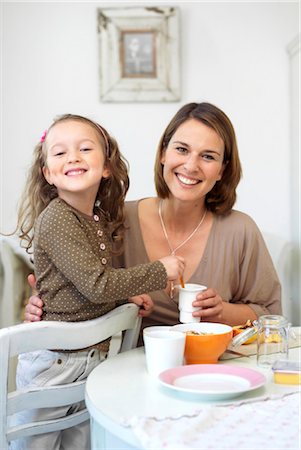 Mother and daughter having fun at breakfast table Stock Photo - Rights-Managed, Code: 853-02913722