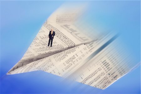 stock market - High angle view of figurine of businessman standing on paper airplane Stock Photo - Rights-Managed, Code: 853-03227723