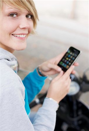 phone and numbers - Young woman with mobile phone, eye contact Stock Photo - Rights-Managed, Code: 853-03458842