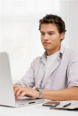 people writing numbers - Young man using notebook, waist up Stock Photo - Rights-Managed, Code: 853-03458876