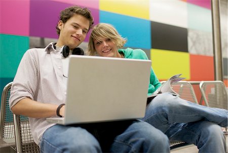 Teenager couple using laptop at underground station, low-angle view Stock Photo - Rights-Managed, Code: 853-03458877