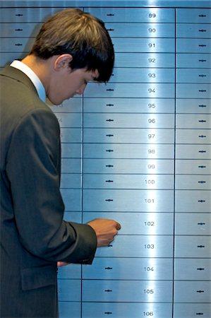 formal jackets for men - Man opening safe deposit box Stock Photo - Rights-Managed, Code: 853-03616795