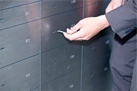 Man opening safe deposit box, close-up Stock Photo - Rights-Managed, Code: 853-03616805
