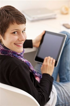 sit on top of desk - Young woman using iPad Stock Photo - Rights-Managed, Code: 853-03616844