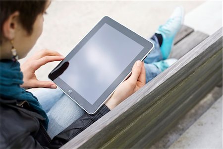 easy - Young woman using iPad on a bench Stock Photo - Rights-Managed, Code: 853-03616854