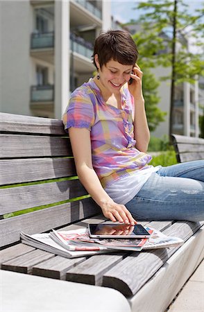 simsearch:853-06120359,k - Young woman with cell phone and iPad on a bench Stock Photo - Rights-Managed, Code: 853-03616864