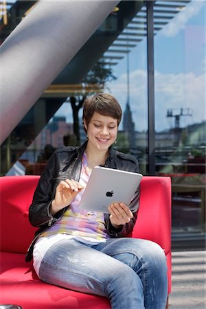 seating furniture - Young woman using iPad Foto de stock - Con derechos protegidos, Código: 853-03616874