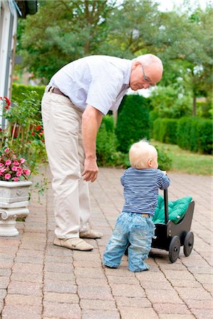 Grandfather and toddler with doll's pram outdoors Stock Photo - Rights-Managed, Code: 853-03616917