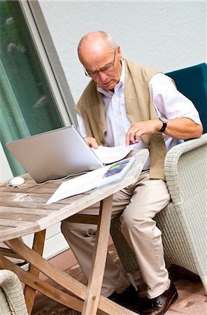 Senior man using laptop on terrace Stock Photo - Rights-Managed, Code: 853-03616942