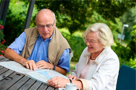 senior women chat - Senior couple on terrace looking in road map Stock Photo - Rights-Managed, Code: 853-03617030